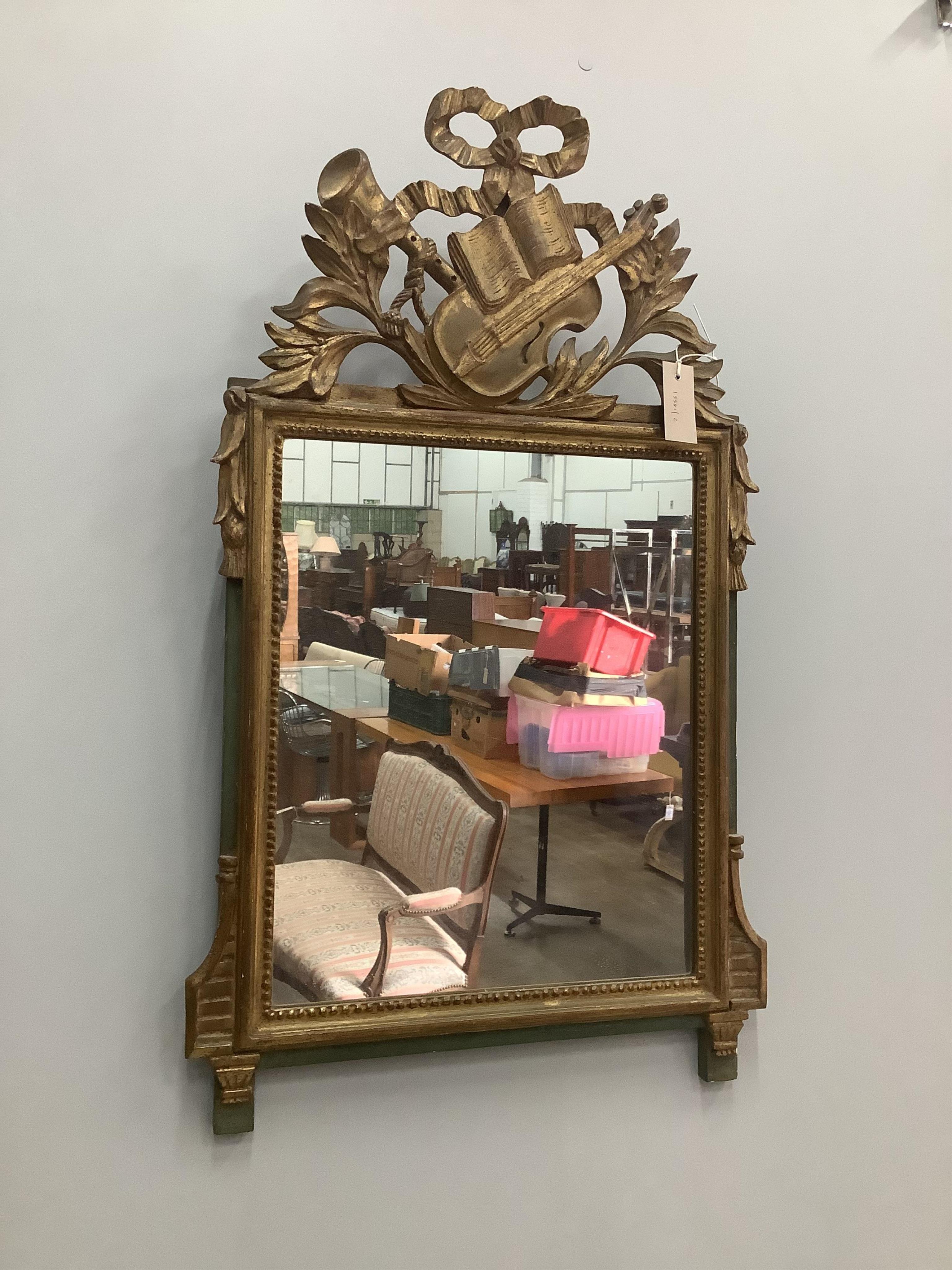 A carved giltwood wall mirror, width 50cm, height 84cm. Condition - fair